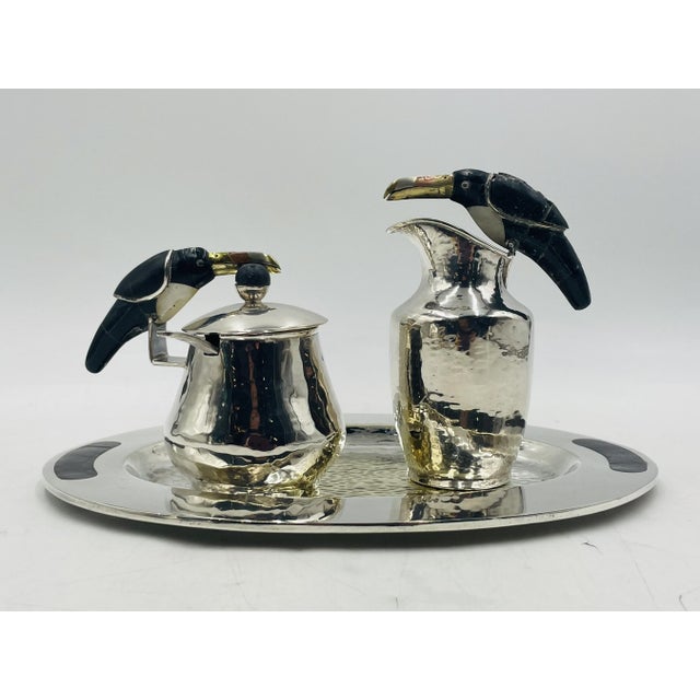 A whimsical and highly collectible four-piece silverplated tea service designed by celebrated Mexican artist Emilia...