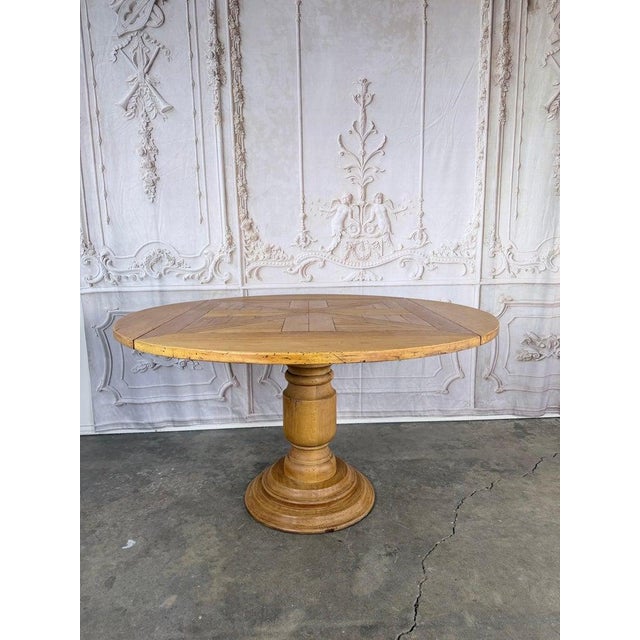 Exceptional 19th-century French Provincial pedestal table with drop-leaf top. This versatile table functions as both a...