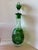A tall, elegant wine decanter in deep emerald green cased over clear crystal, hand-cut in the classic Bohemian/Bavarian...