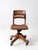 A swivel desk chair by Gunlocke, dating from the 1930s–1940s, featuring a sculpted oak seat, curved slat back, and sturdy...