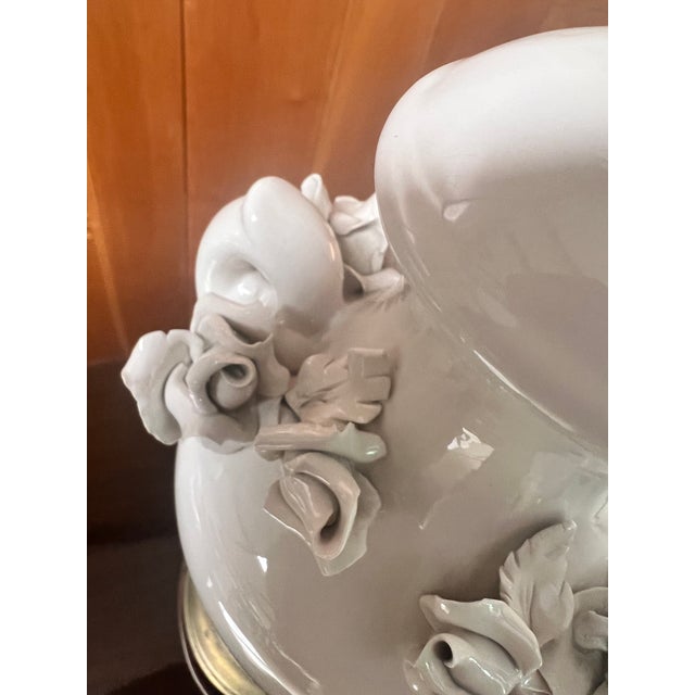 Vintage mid-century creamy porcelain urn-style table lamp, featuring delicate applied porcelain roses across the front and...