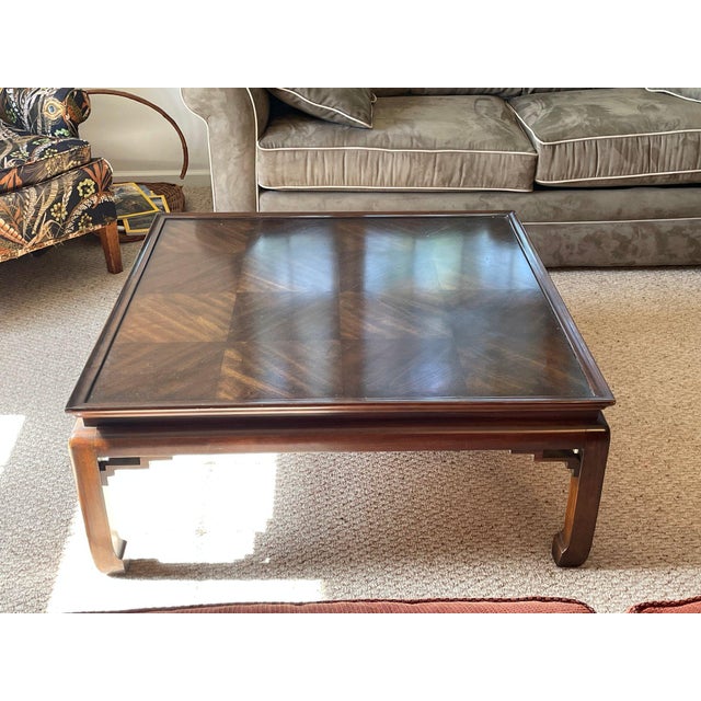 A vintage late 20th century square coffee table with a shaped apron and curved slipper feet. This is a solid, well-made...