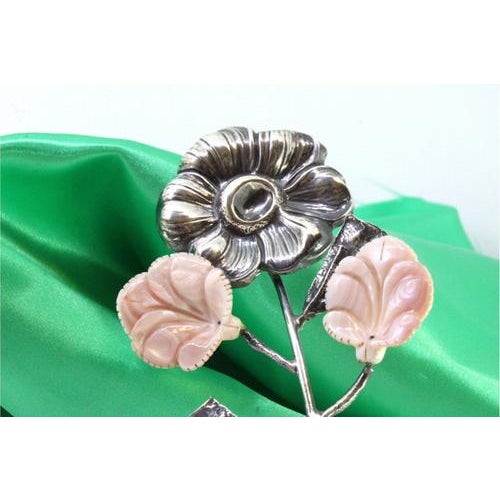 Silver Flower with Reliefs and Ceramic Applications, in Very Good conditions. Designed 1980 to 1989 This piece has an...