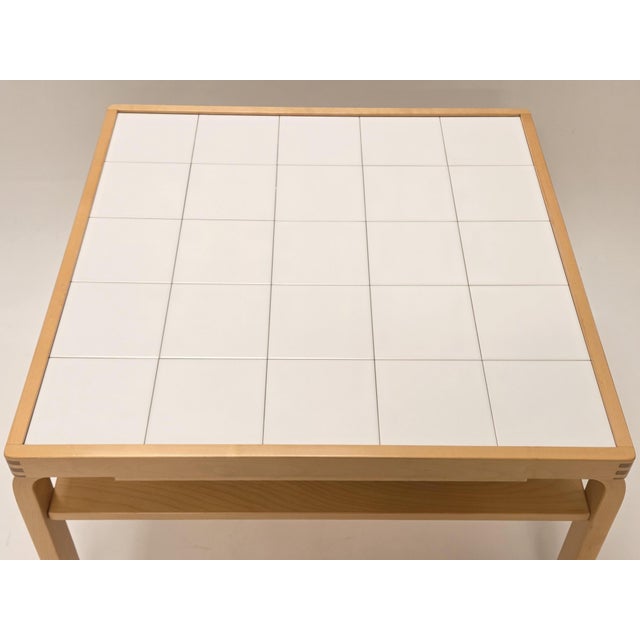 Artek 910 coffee table, birch with white tiles. In good used condition. Designer Aino Aalto. Artek's stamp on the base....