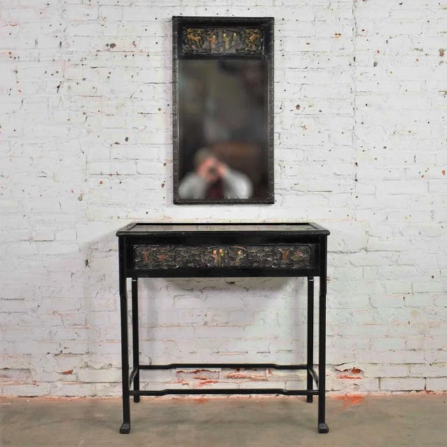 Handsome antique Asian black lacquered console table and matching mirror with exceptional deep hand carved lacquer details...