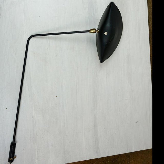 This fantastic rare original adjustable pivoting single arm wall lamp was designed and manufactured by Serge Mouille,...