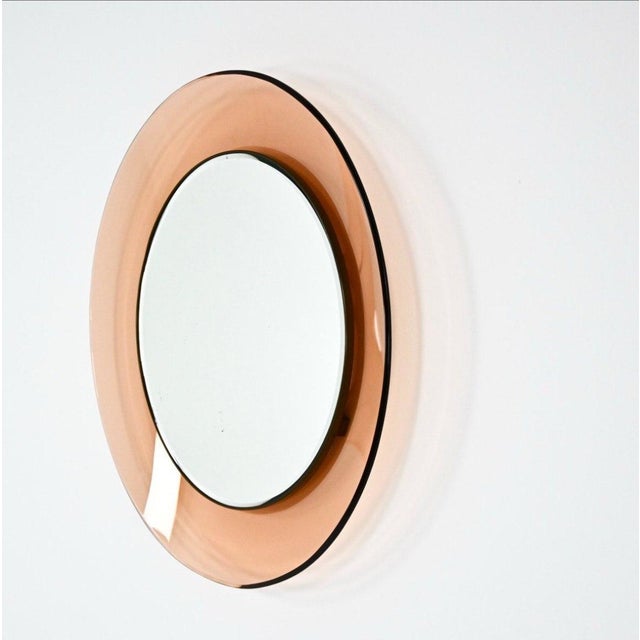 Structure composed of a central circular mirror set in a concave frame of colored and curved crystal. I have official...