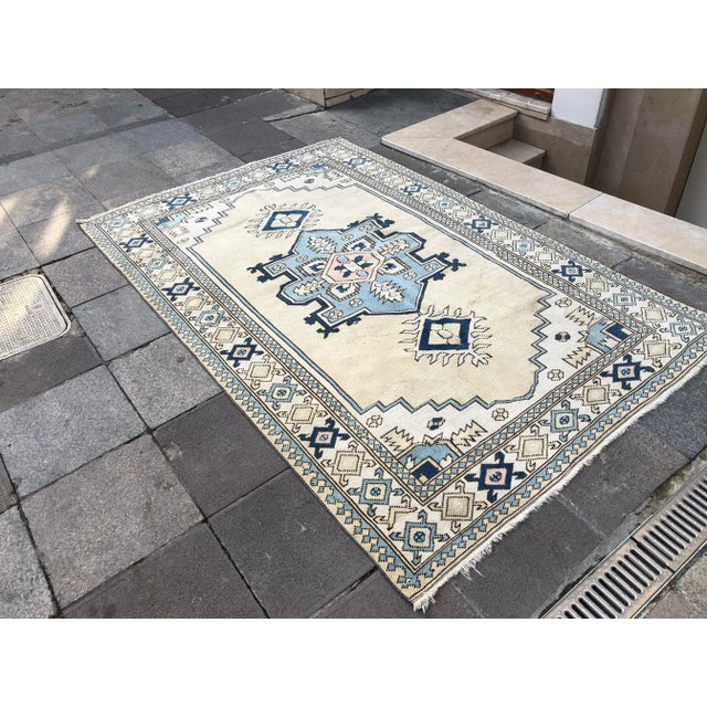 This is a vintage Turkish Oushak rug from the 1960s. The piece was hand-knotted.