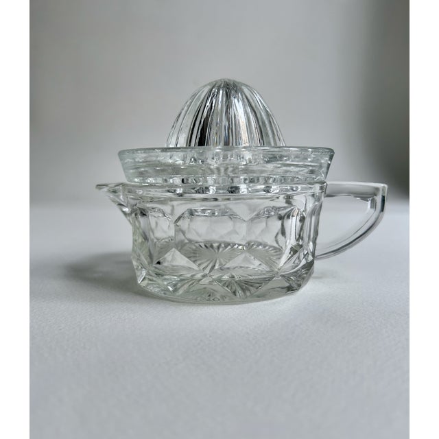 Early 20th Century Heisey Glass Two Piece Clear Handled Perforated Glass Juicer. Featuring a 2 piece jug form with 10...