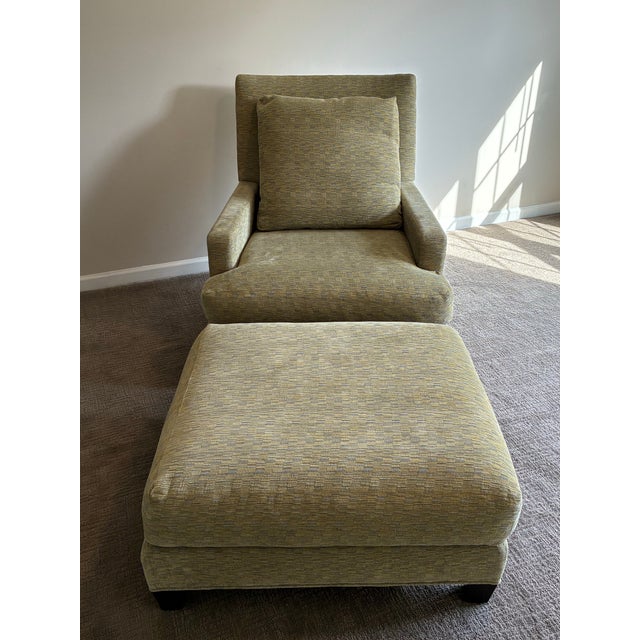Exceptional Baker lounge chair and matching ottoman presented in virtually unused, showroom-like condition. Upholstered in...