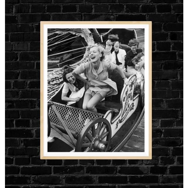 Two young women enjoying themselves on the 'Caterpillar' ride at Southend Fair, Essex, October 1938. As an authorized...