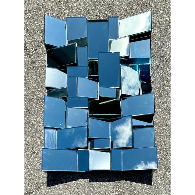 This vintage "Slopes" mirror, created in the style of Neil Smalls, presents a fractured, cubist-inspired composition of...
