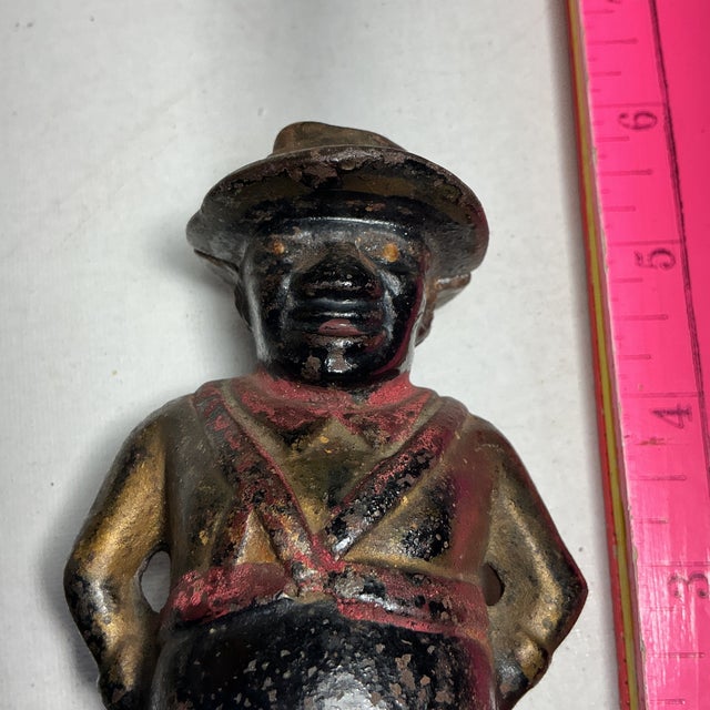This is an antique A.C. Williams "Sharecropper" still bank, produced around 1910.The cast iron bank depicts a caricature...