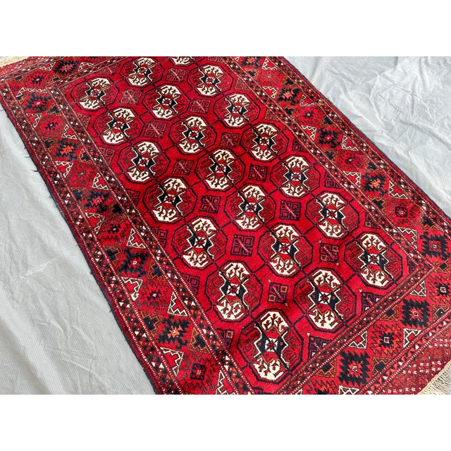 This hand-knotted Bokhara rug carries the classic Tekke gul design — rows of octagonal "elephant's foot" medallions in...