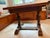 A stately Jacobean Revival refectory table in solid English oak, dating to the early-to-mid 20th century. This piece is...
