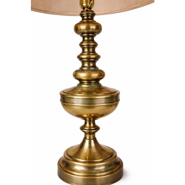 Vintage traditional brass-finished table lamp with warm aged patina and classic turned silhouette. Newly updated with...
