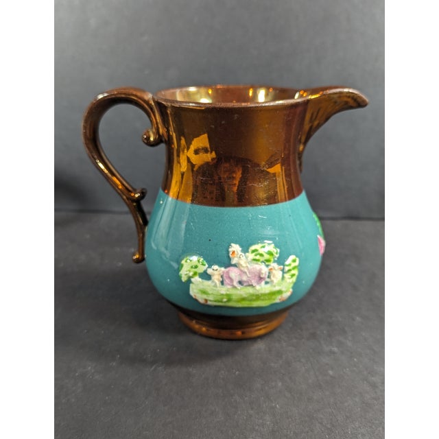 This mid 19th century Copper painted pitcher with vivid teal glaze and brightly colored scenes is made in the 1850's in...