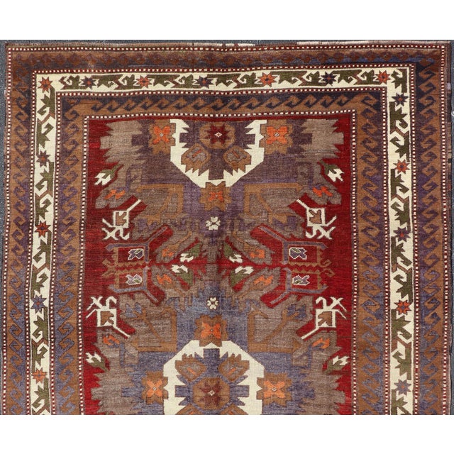 Measures: 7'8'' x 10'3''. This vintage Turkish Oushak gallery rug (circa mid-20th century) features a unique blend of...