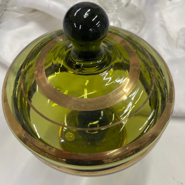 Lovely example of European art glass with the original sticker still intact. This olive green hand blown lidded candy dish...