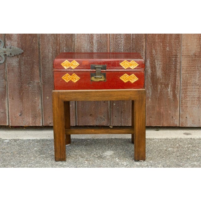 Chinese antique crimson gilt lacquer leather document box. It features a gilt geometric design on the outside and a blue...