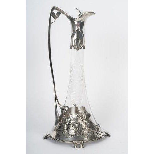 This magnificent claret jug by the silversmith Orivit is a prime example of the Art Nouveau movement, dating from circa...