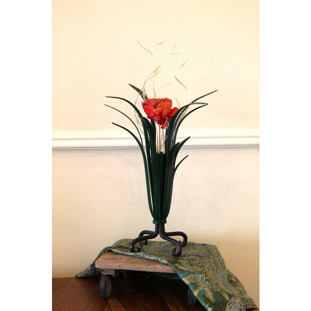An excellent vintage vase, shaped metal leaves with a center metal vase. It sits on top of a base with scrolled feet,...