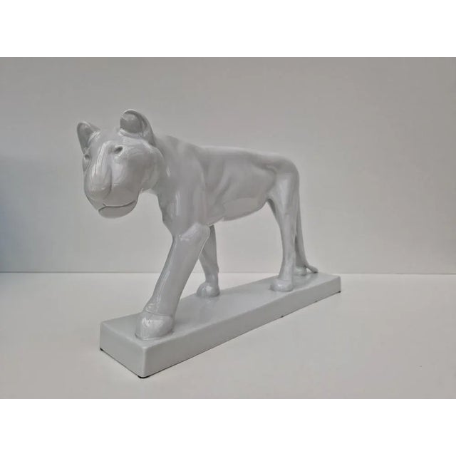 Naturalistic form in white -porcelain, rectangular cat stranded on narrow rectangular base. Design by Gerhard Marcks,...