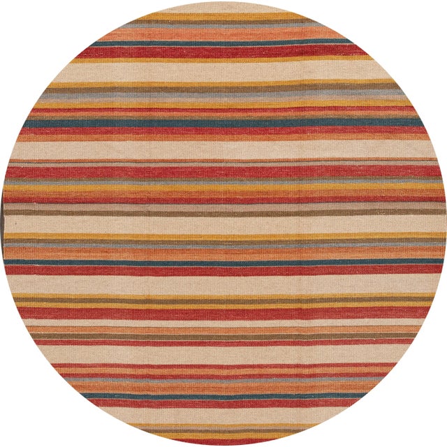 A beautiful hand-woven modern Kilim rug with a tan field and multi-color accents in an all-over geometric design. This rug...