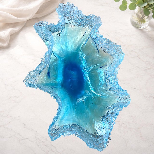 A large handmade ocean wave bowl crafted from epoxy resin with crushed glass accents in Naples, Florida. The flowing...