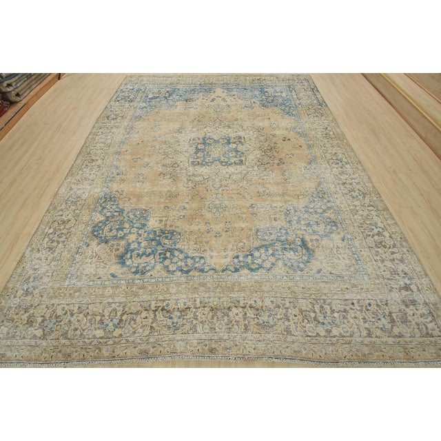 An authentic vintage traditional Tabriz rug hand-knotted with fine wool and natural dyes. This oriental rug features muted...