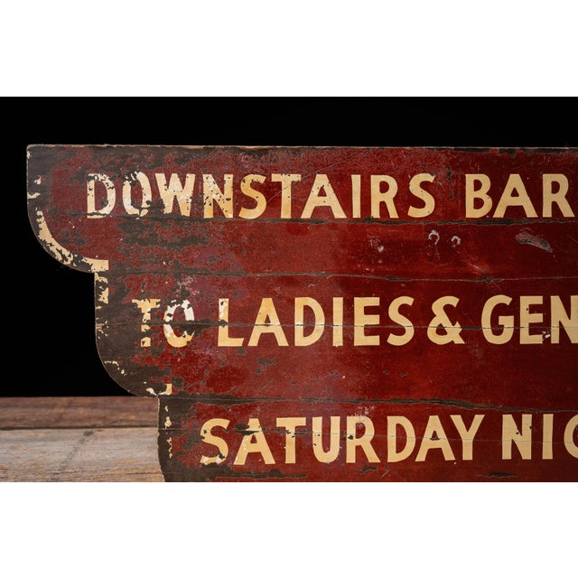Double-sided hand-painted plywood advertising sign directing patrons to a downstairs bar. The stepped Art Deco-inspired...