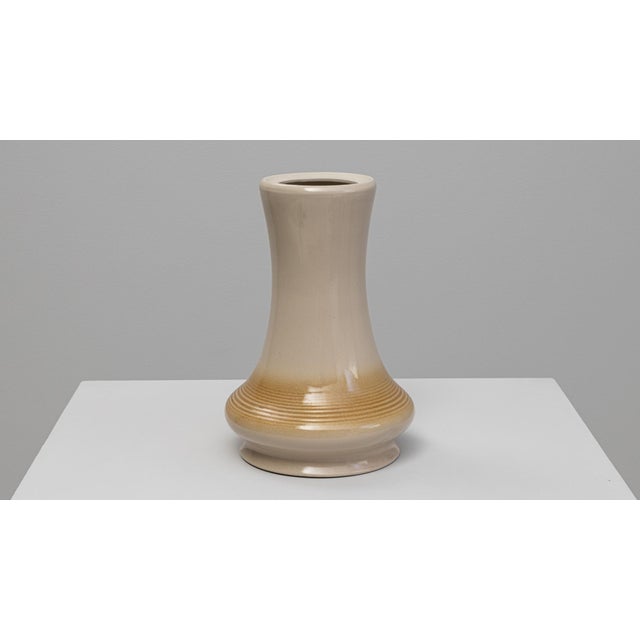This elegant mid-century vase features a softly contoured silhouette with a gently flared neck and rounded base,...