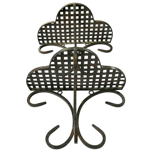 A striking pair of antique French wrought iron wall shelves, hand-forged with an elegant balance of utility and ornament....