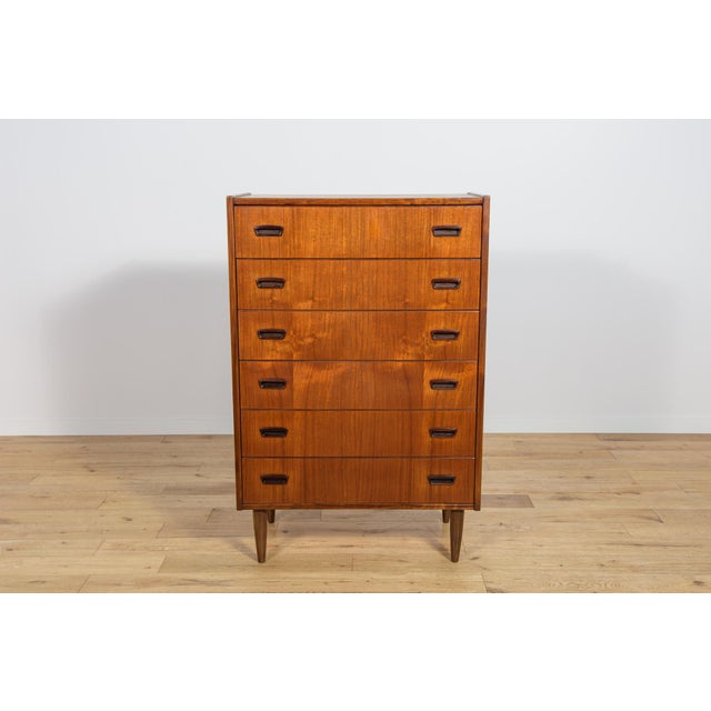 Teak dresser with six drawers made in the 1960s in Denmark. The dresser has contoured handles. The dresser has undergone a...