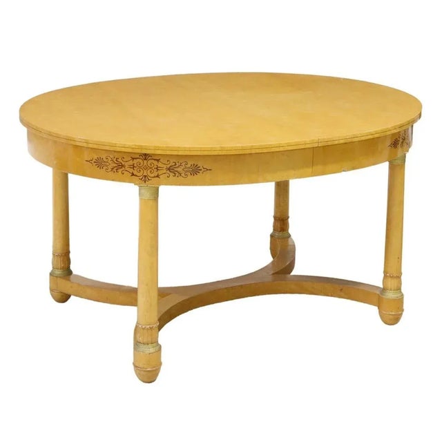 French Empire style birdseye maple extension table, late 20th c., oval tabletop, apron with contrasting marquetry inlay,...