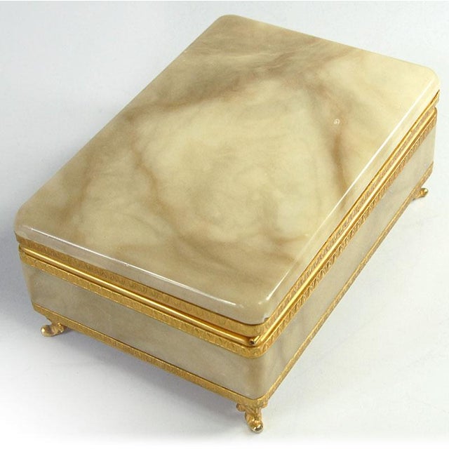 A beautiful, delicate container with a hinged lid/casket. Crafted from light, polished marble, the edges are finished with...