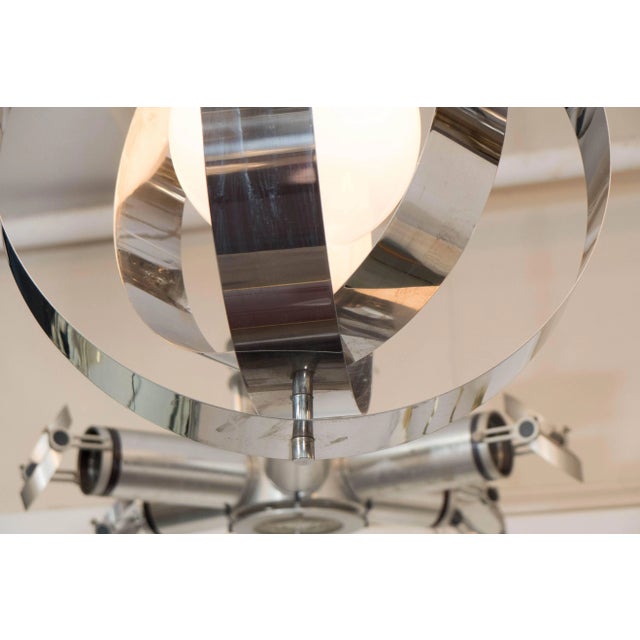 Italian Armillary Style Globe Pendant Lamp, 1970s, the frosted glass globe surrounded by three layers of polished chrome...