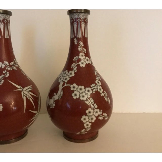 A pair of Chinese Cloisonne vases in cinnabar and white color. The gord form with slim taper neck and bulbous body. The...