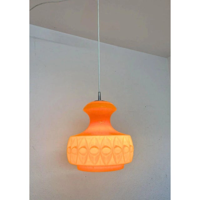 Stunning 1970s ceiling lamp model AH 129 designed by Peill and Putzler in sculpted geometric pattern orange opaline glass...
