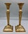 A striking pair of antique French brass-finished candlesticks in the Empire style, dating to the early 20th century. Each...