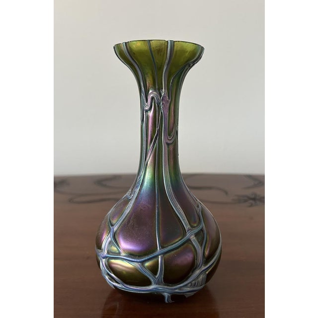 Blown glass vase produced by Pallme König. The intensely iridescent favrille glass is decorated with interwoven glass...