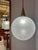 The elegant glass and teak globe lamp from Doria impresses with its harmonious design and high-quality materials. The...