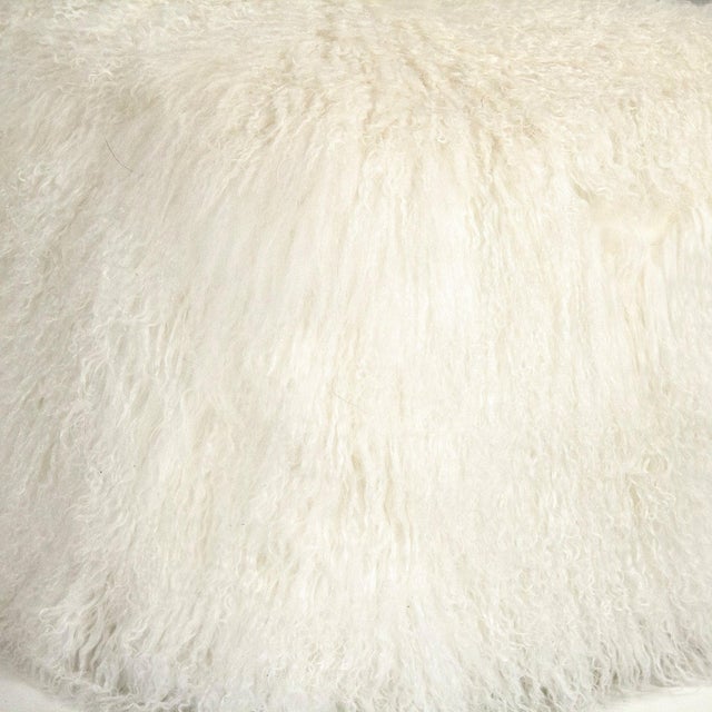 The 24" x 24" Tibetan White Lamb Fur Pouf from Zentique is a luxurious floor pouf covered in plush white Tibetan lamb fur....