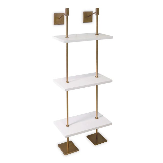 Modern multi-tier shelf in aged brass and white shelves, details urban simplicity with burnished finishes. Marais Shelf...