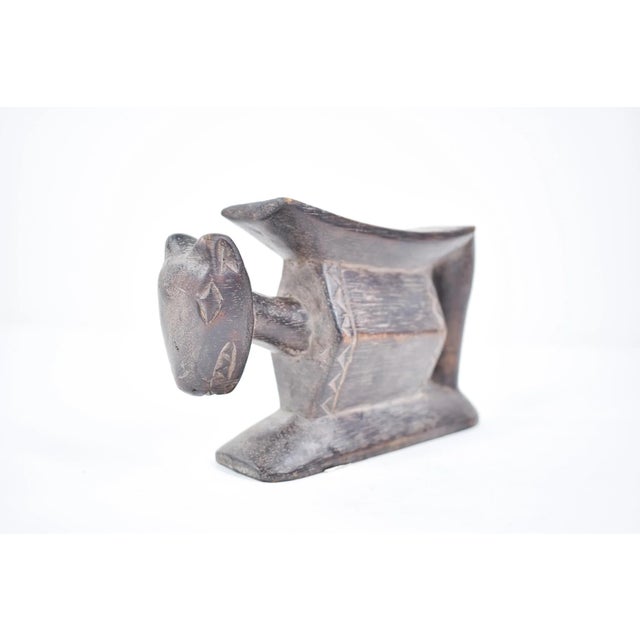 This elegant headrest originates from the Baule people of CÃ´te d'Ivoire (Ivory Coast), renowned for their refined...