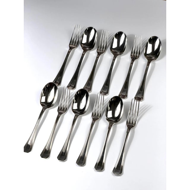 Elegant silver-plated cutlery set by Christofle, Paris, from the Boréal collection. This refined modernist design features...