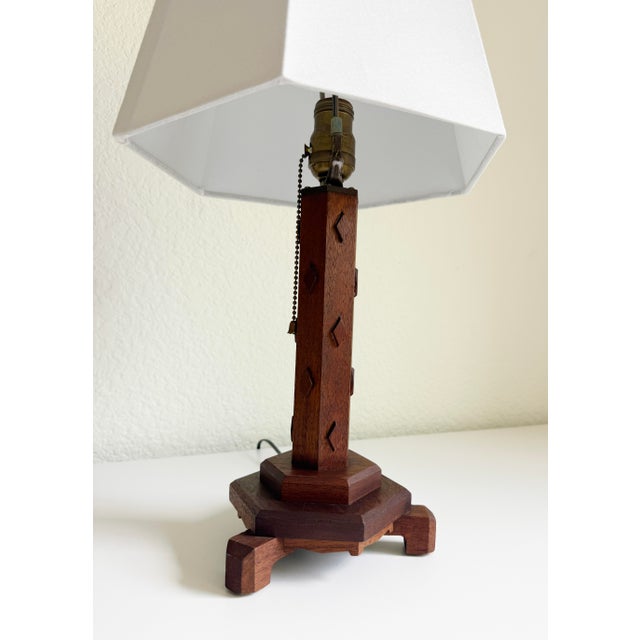 Exuding warmth and charm, this wood table lamp features a hexagonal column crafted from dark-stained walnut wood, subtly...