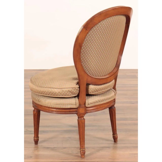 A very comfortably upholstered diminutive chair Well made of walnut with a slight tasteful gilt decorations