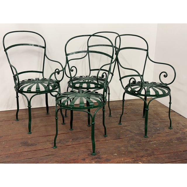 A set of four wrought iron chairs designed by Francois Carre. This is set is a fine earlier set possibly dating it to...