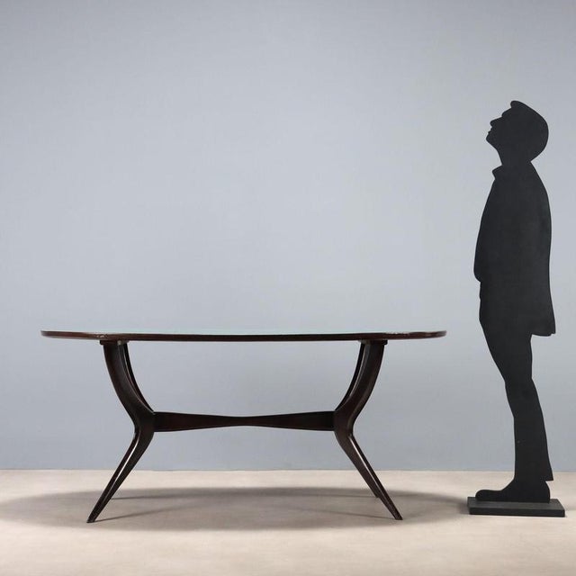 Dining table with stained beech wood frame and oval Formica top. This piece is attributed to the mentioned designer/maker....